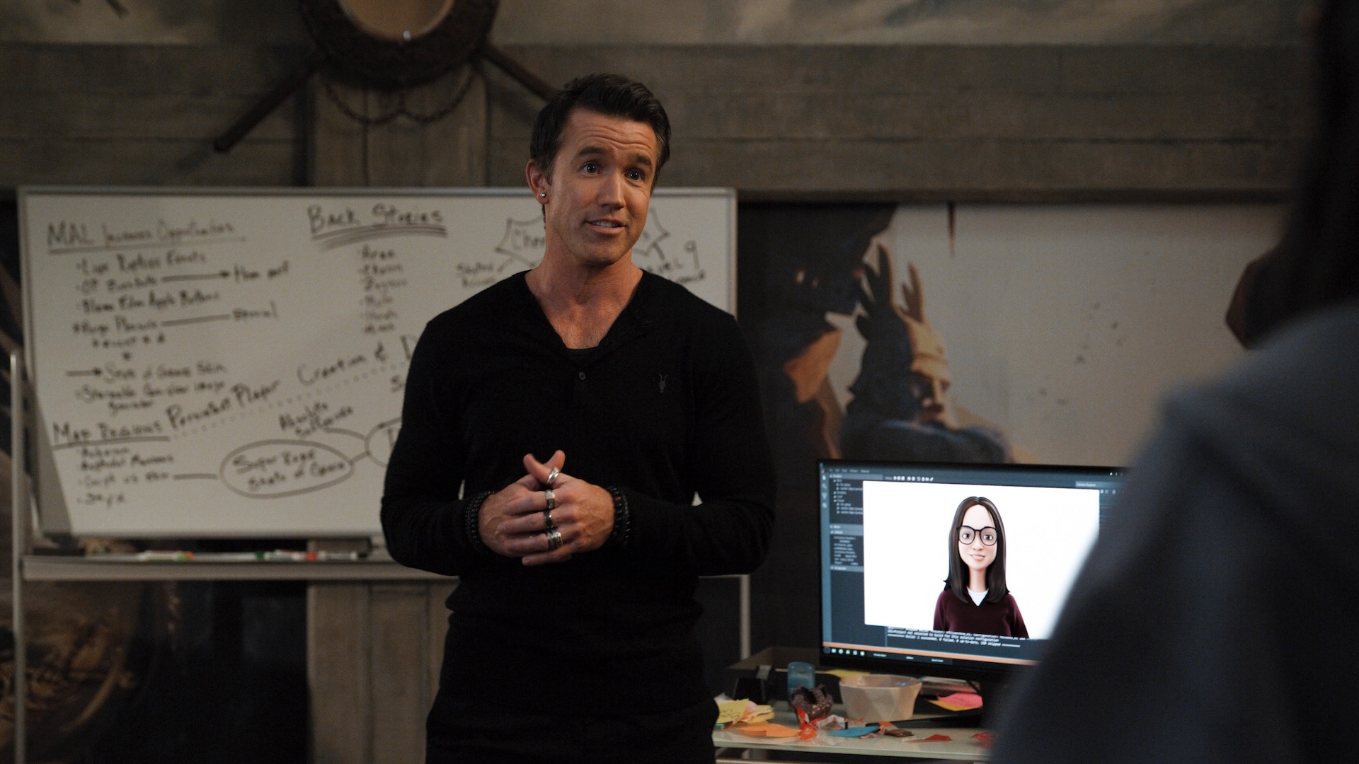 Ian Grimm (Rob McElhenney) stands in front of a white board in Mythic Quest season 4.