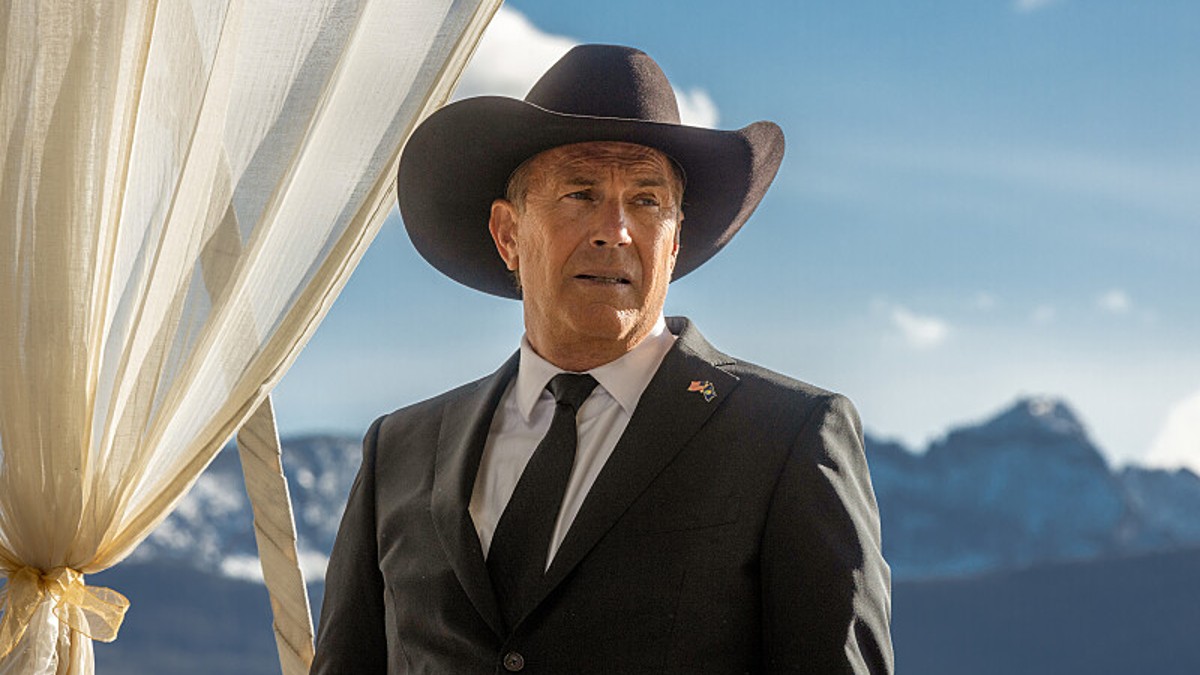 Kevin Costner wearing a suit and a cowboy hat in Yellowstone