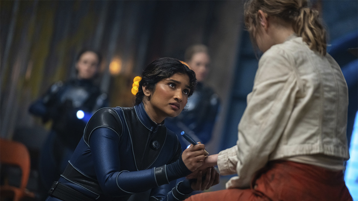 Varada Sethu administering medicine to Rose Ayling-Ellis in Doctor Who episode "The Well"